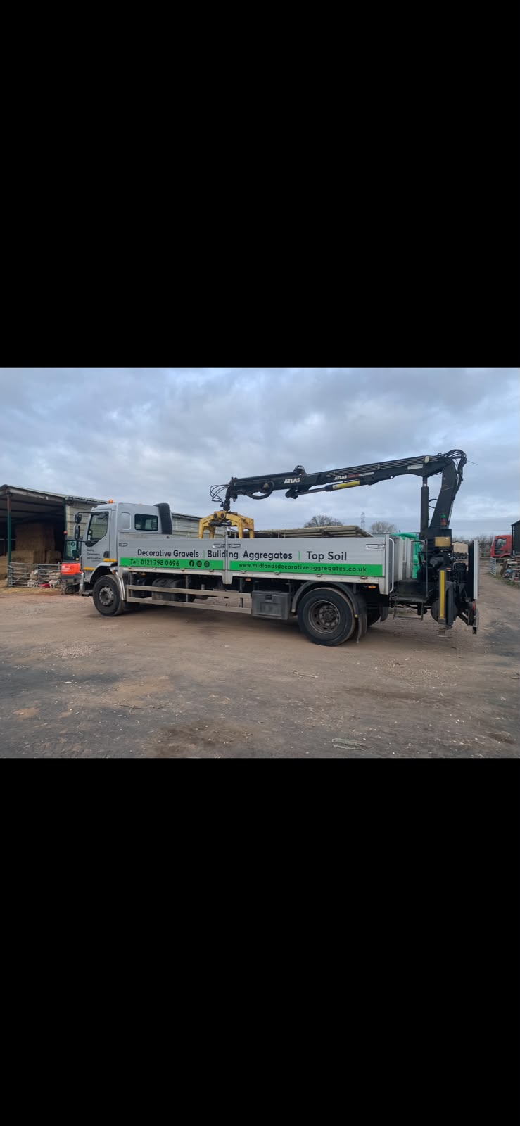 The Midlands Decorative Aggregates delivery lorry with its crane at the yard